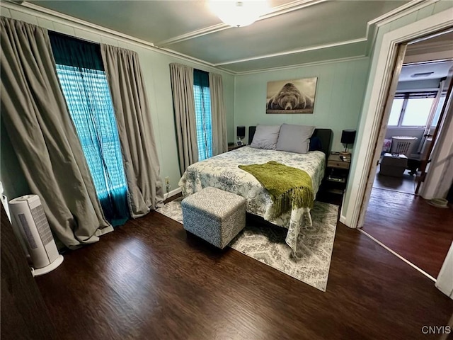 bedroom featuring dark hardwood / wood-style flooring and crown molding