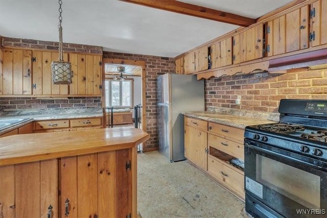 kitchen with stainless steel fridge, brick wall, ceiling fan, pendant lighting, and black gas stove