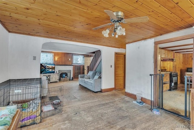 living room featuring hardwood / wood-style flooring, ceiling fan, and wood ceiling