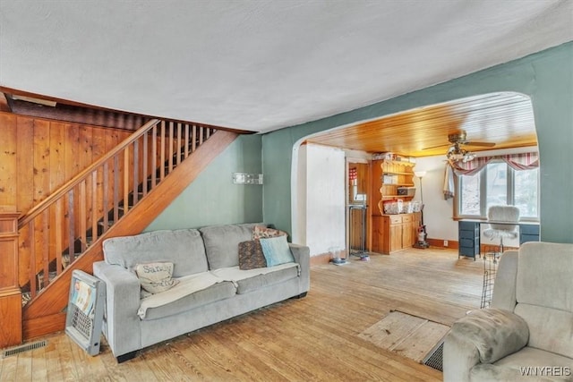 living room featuring ceiling fan and hardwood / wood-style floors