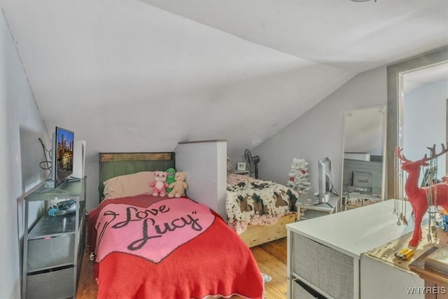 bedroom with hardwood / wood-style floors and vaulted ceiling