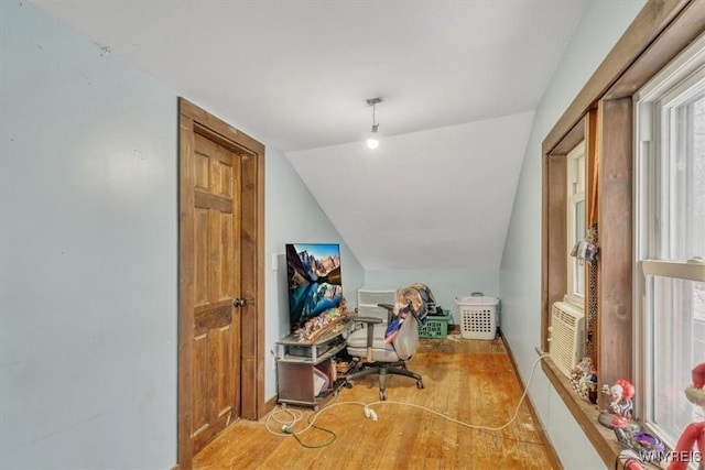 home office featuring cooling unit, light wood-type flooring, and lofted ceiling