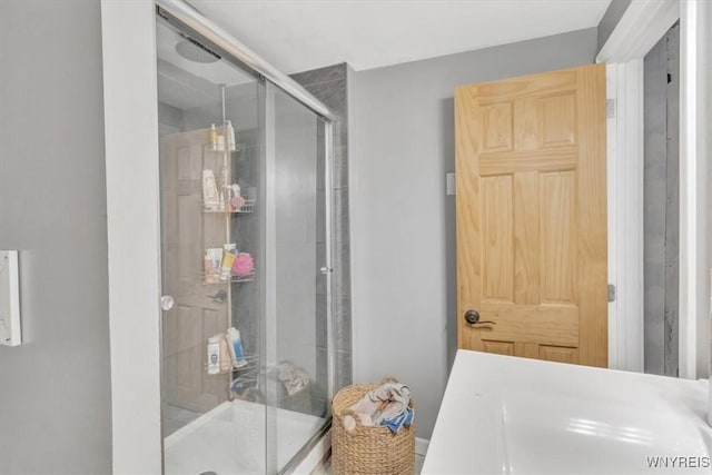 bathroom featuring a shower with shower door