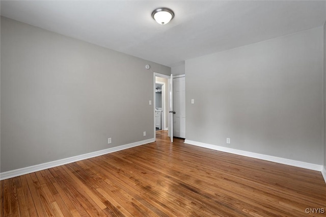 empty room with hardwood / wood-style flooring