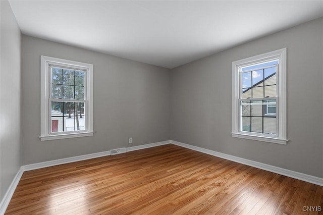 unfurnished room with light hardwood / wood-style floors