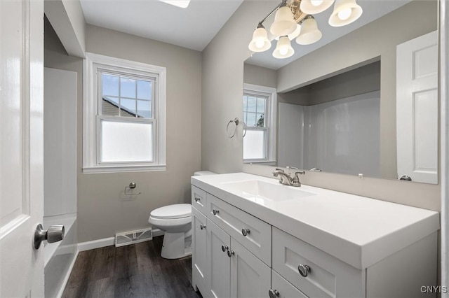 bathroom with vanity, hardwood / wood-style flooring, and toilet