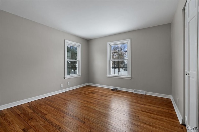 unfurnished room with wood-type flooring