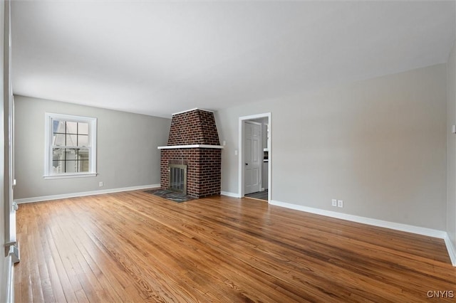 unfurnished living room featuring a fireplace and hardwood / wood-style floors