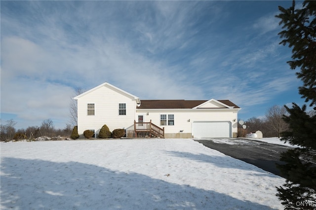 view of front of house with a garage and aphalt driveway