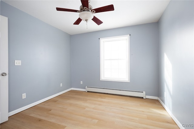 unfurnished room featuring a ceiling fan, baseboards, baseboard heating, and wood finished floors