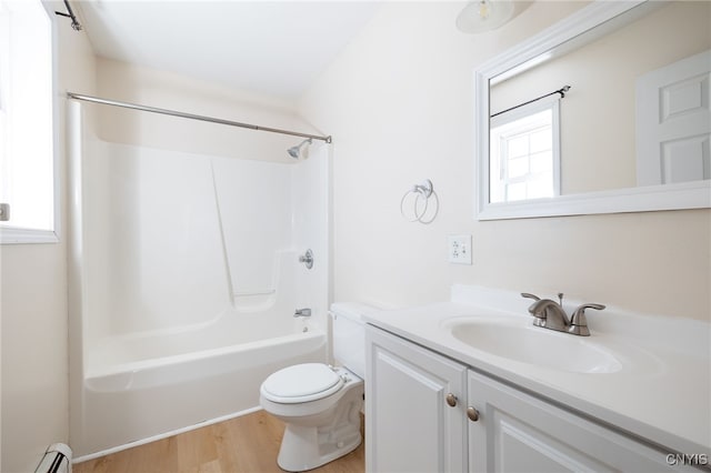 full bathroom featuring toilet, a baseboard heating unit, wood finished floors, vanity, and tub / shower combination