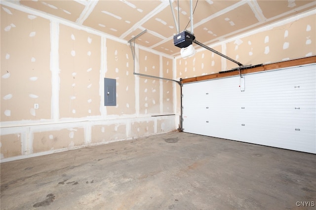 garage with a garage door opener and electric panel