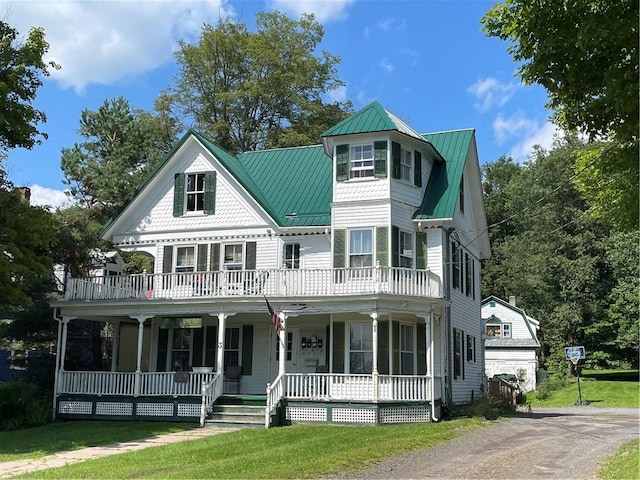 view of front of property with a front yard and a porch