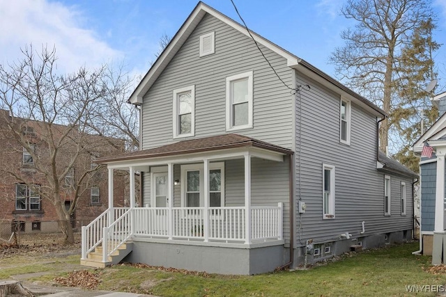 front of property with covered porch and a front yard