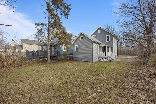 back of house with a lawn