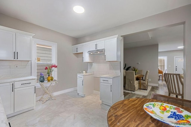 kitchen featuring decorative backsplash and white cabinetry