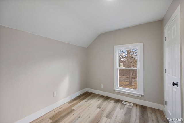 bonus room featuring light wood-type flooring and lofted ceiling