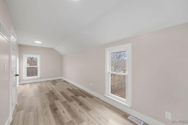 bonus room with lofted ceiling and light hardwood / wood-style flooring