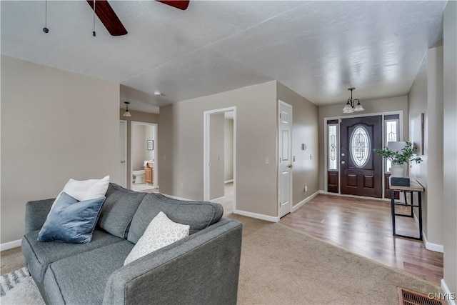 entrance foyer with carpet and ceiling fan