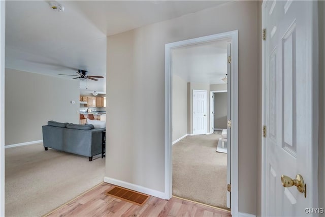 hallway with light hardwood / wood-style flooring