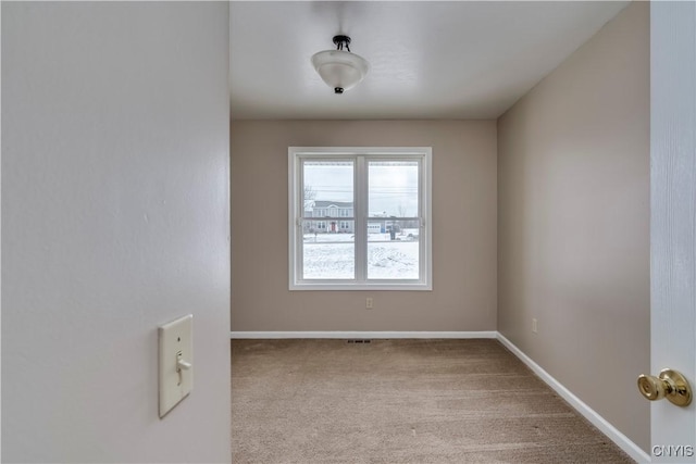 unfurnished room with light carpet