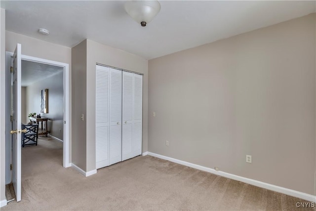 bedroom featuring light colored carpet and a closet