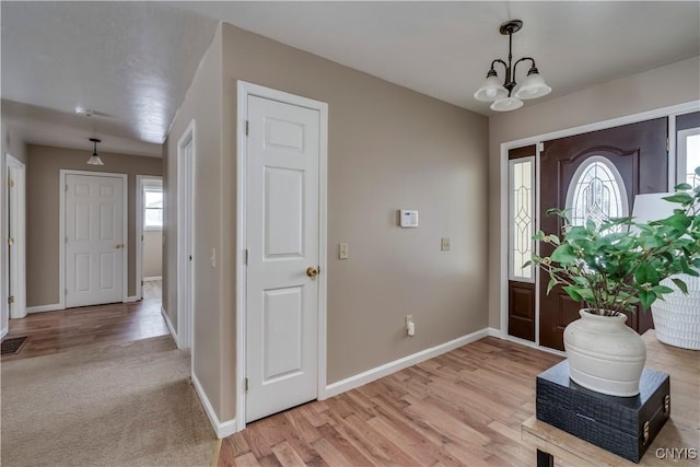 entrance foyer with a notable chandelier and light wood-type flooring