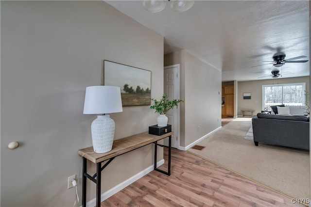 hall featuring light colored carpet