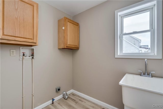 laundry room with cabinets, washer hookup, light wood-type flooring, hookup for an electric dryer, and sink