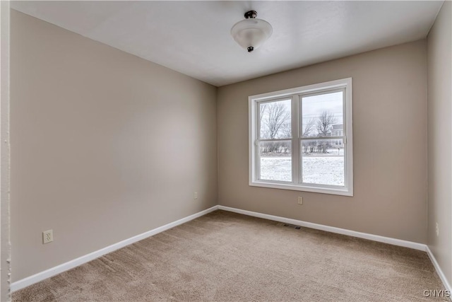 unfurnished room featuring light carpet