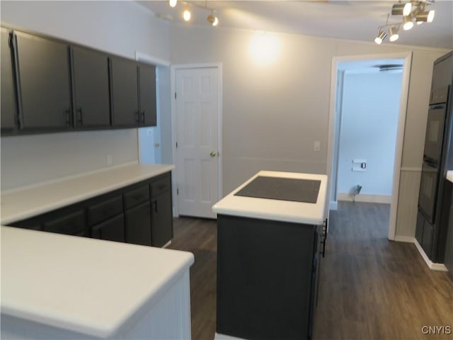 kitchen with a kitchen island, dark hardwood / wood-style flooring, and black electric cooktop