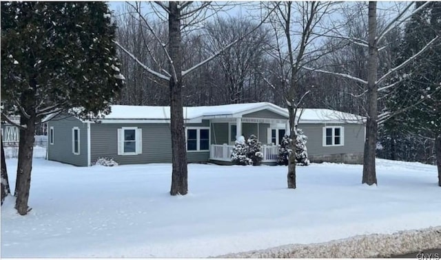 ranch-style home featuring central air condition unit and covered porch