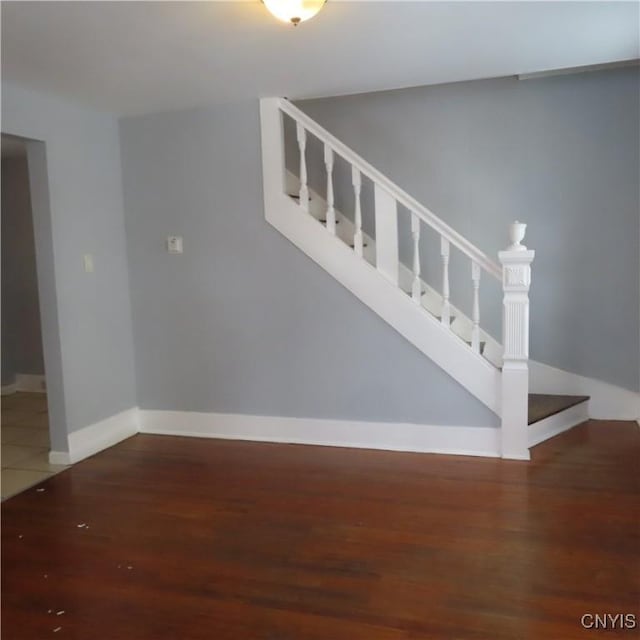 stairs featuring wood-type flooring