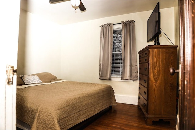 bedroom with ceiling fan and dark wood-type flooring