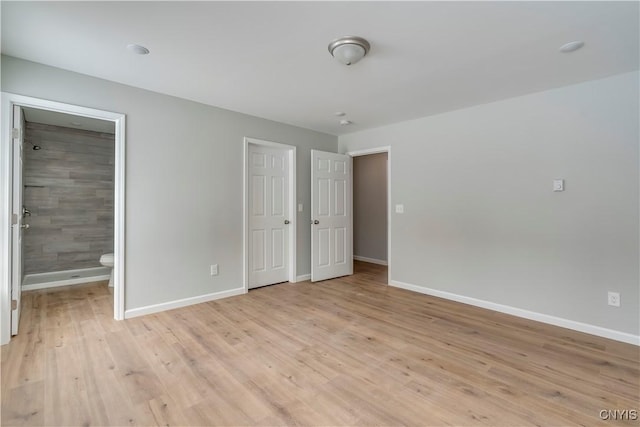6661 Pine Grove Rd, Watson, NY 13343 - unfurnished bedroom with light wood-style floors and ensuite bathroom