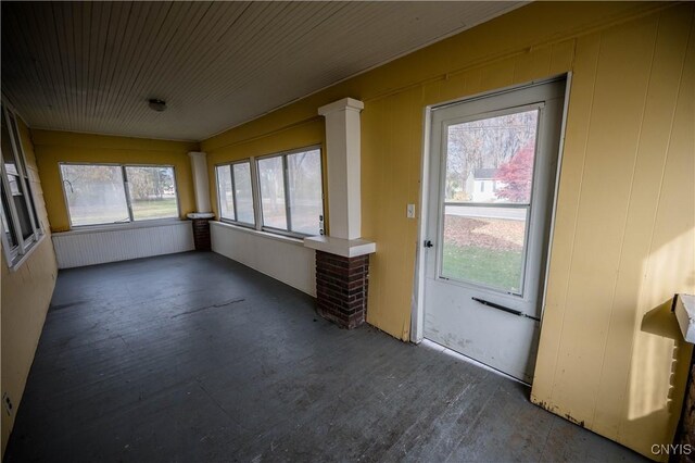 unfurnished sunroom with plenty of natural light