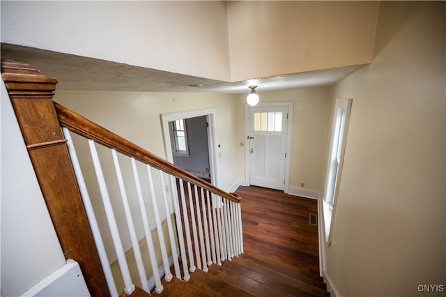 staircase with wood-type flooring