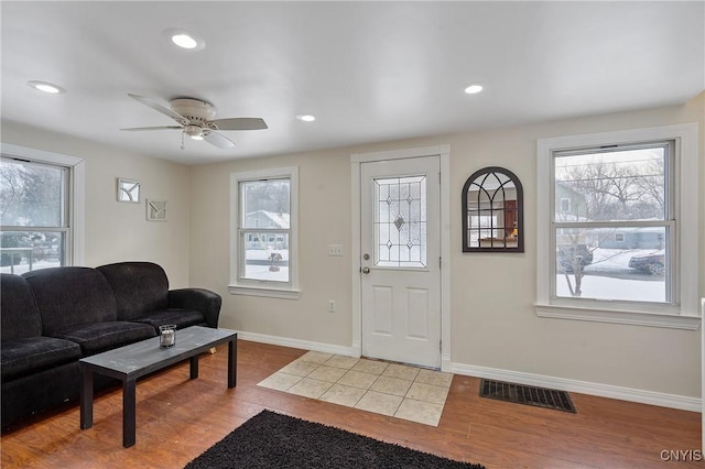 foyer entrance with light wood-type flooring and ceiling fan