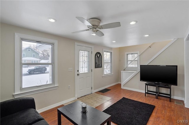 foyer with ceiling fan and wood-type flooring