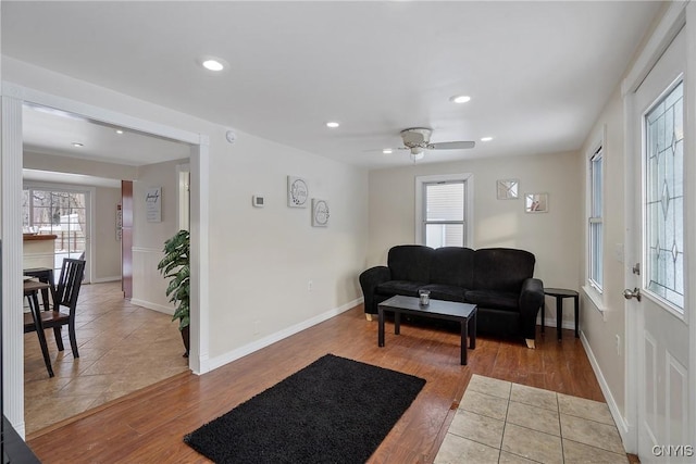 living room with ceiling fan and light hardwood / wood-style floors