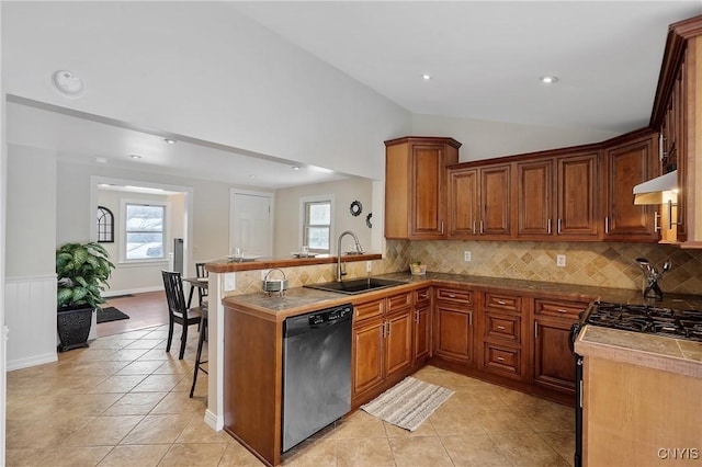 kitchen with black appliances, sink, vaulted ceiling, light tile patterned flooring, and a kitchen bar