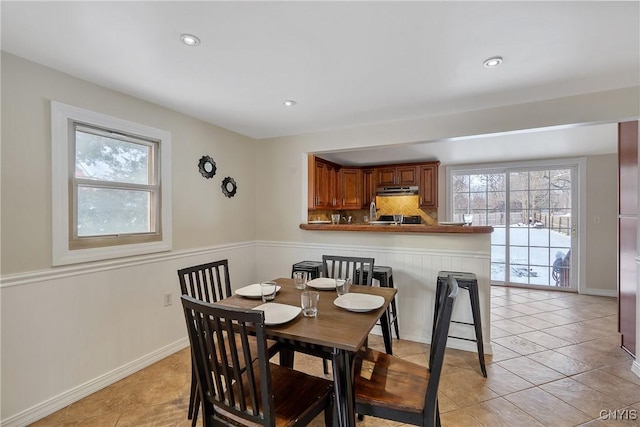 dining area featuring light tile patterned flooring