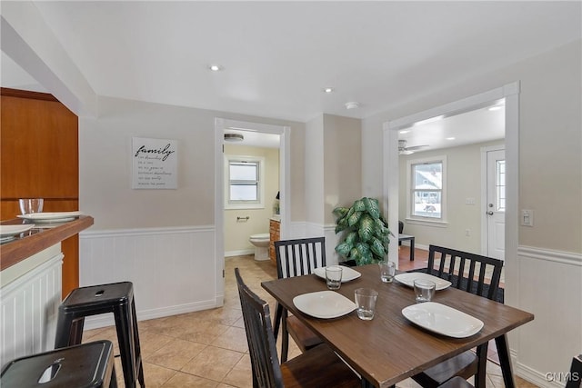 dining area with ceiling fan, plenty of natural light, and light tile patterned floors