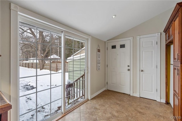 tiled entryway featuring lofted ceiling