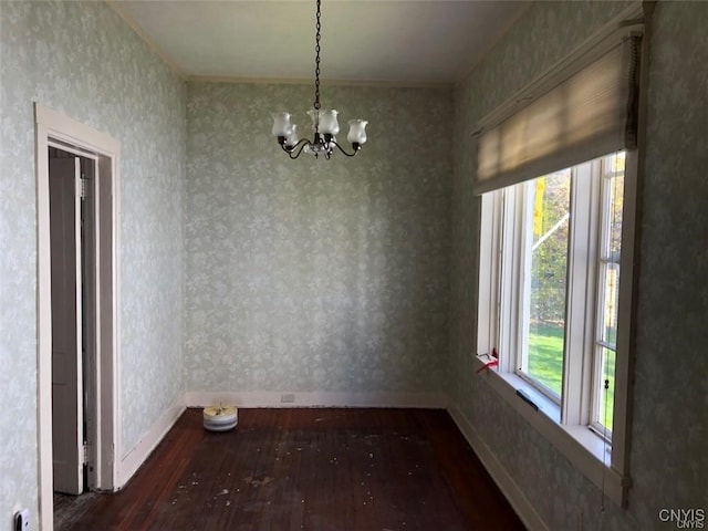 unfurnished dining area featuring a notable chandelier and dark hardwood / wood-style floors