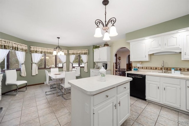 kitchen featuring a notable chandelier, white cabinets, sink, black dishwasher, and decorative light fixtures