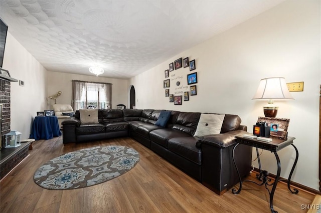 living room with wood-type flooring and a textured ceiling