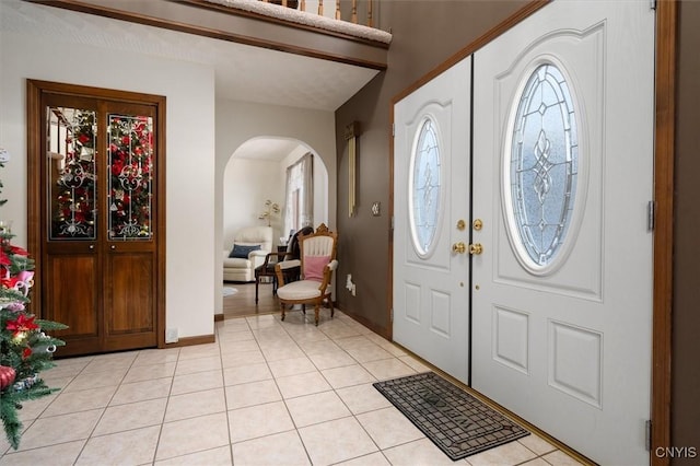 entrance foyer with light tile patterned floors and french doors