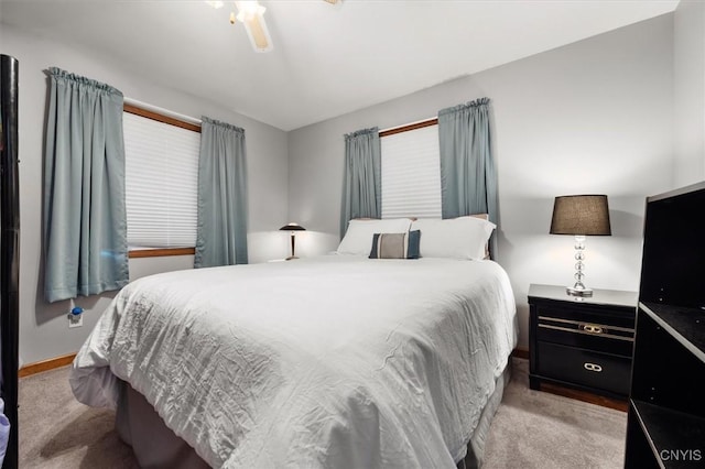 bedroom featuring ceiling fan and light carpet