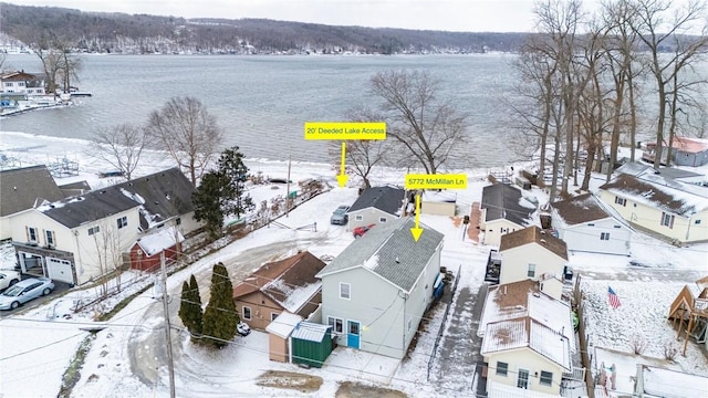 snowy aerial view with a water view